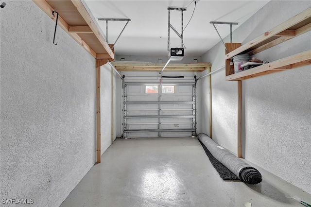 garage with a garage door opener and a textured wall