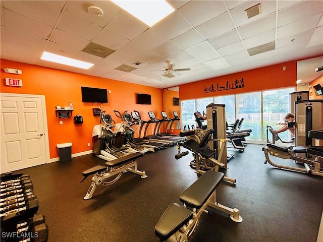 exercise room featuring a drop ceiling and ceiling fan