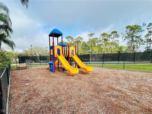 communal playground featuring fence