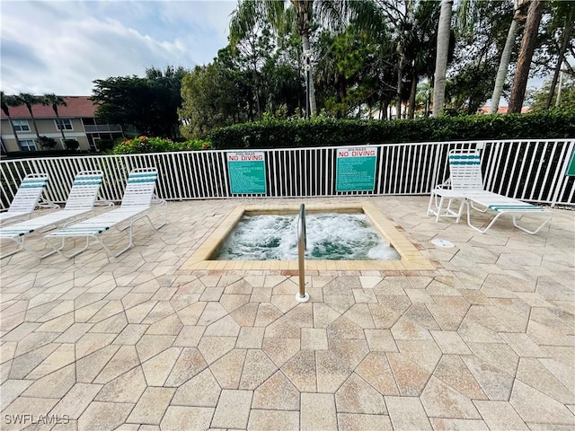 view of pool with a community hot tub and a patio