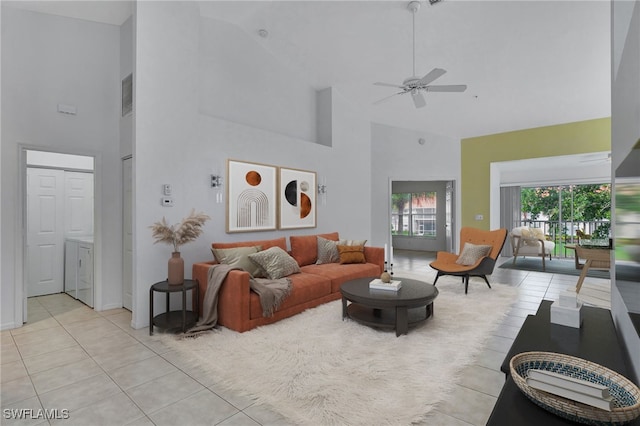 living room with visible vents, a high ceiling, light tile patterned flooring, and a ceiling fan