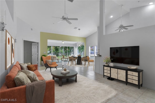 living room featuring light tile patterned floors, ceiling fan, visible vents, and high vaulted ceiling