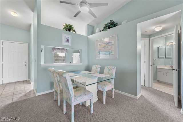 dining space featuring ceiling fan and light colored carpet