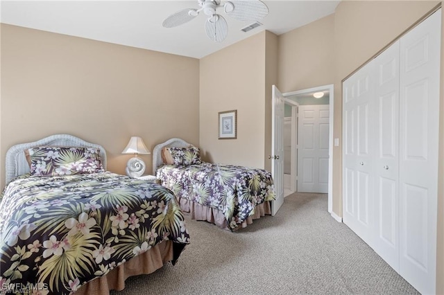 carpeted bedroom with a closet and ceiling fan