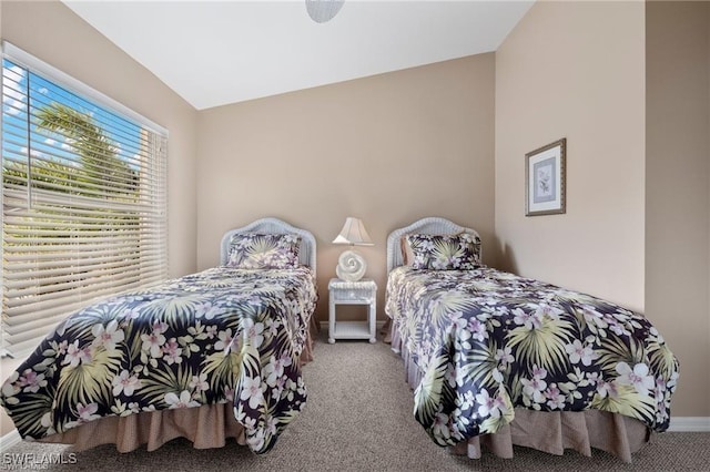 carpeted bedroom featuring lofted ceiling