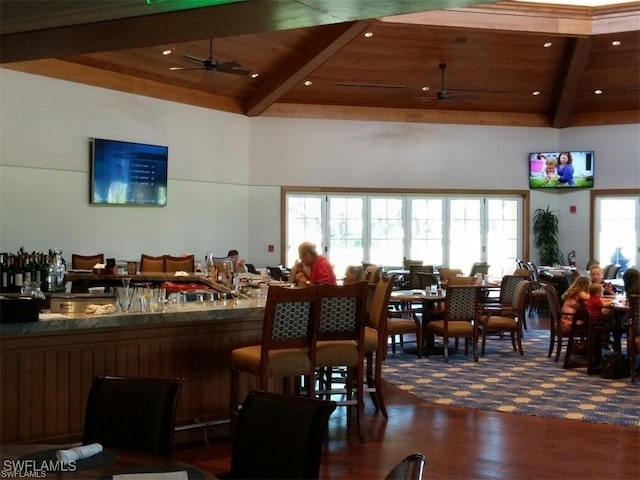 interior space with beamed ceiling, dark wood-type flooring, ceiling fan, and wooden ceiling