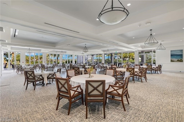 dining space featuring a raised ceiling and light carpet