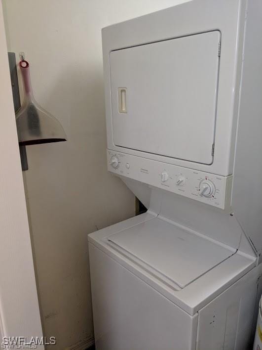 washroom featuring stacked washer / drying machine