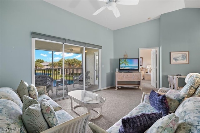 carpeted living room featuring ceiling fan and lofted ceiling