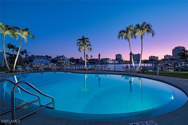 view of pool at dusk