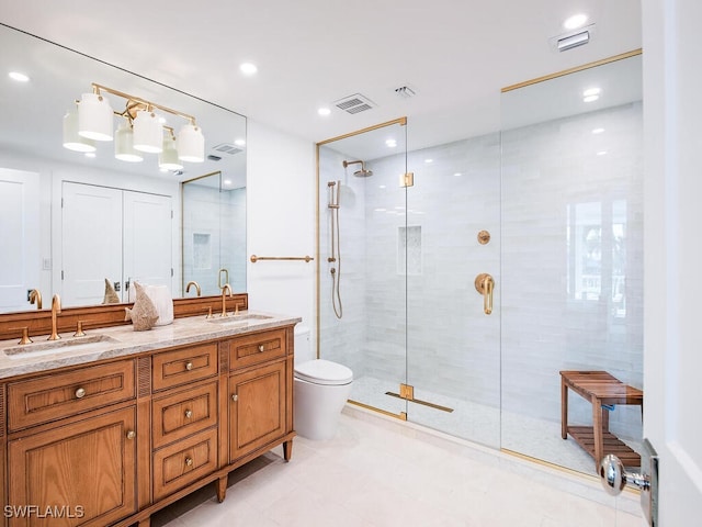 bathroom featuring vanity, toilet, and a shower with door