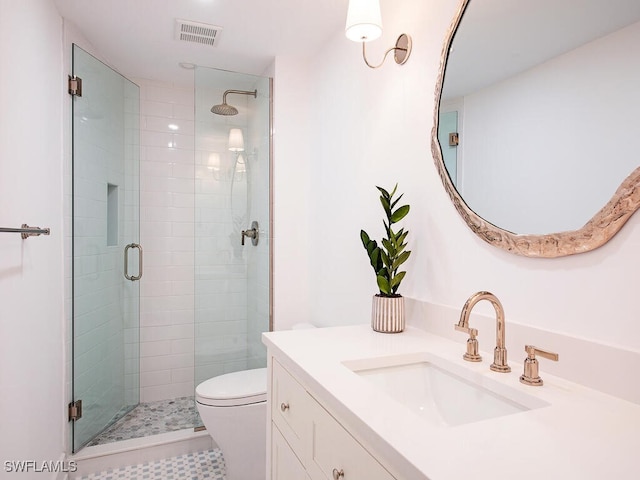 bathroom with vanity, toilet, and walk in shower