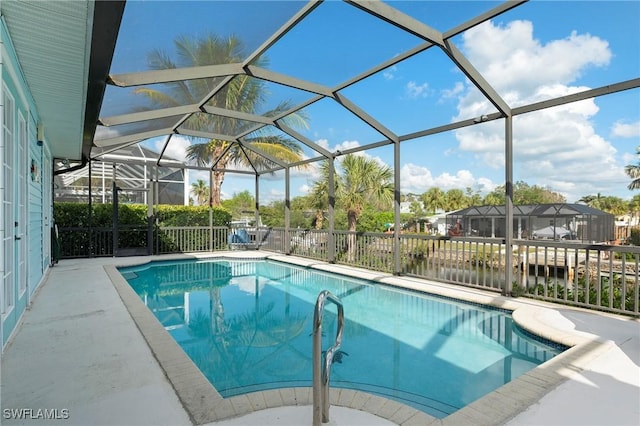 view of pool with a lanai and a water view