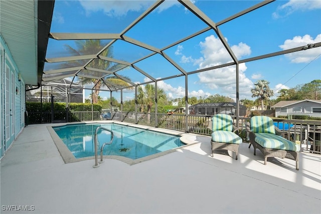 view of swimming pool featuring a lanai and a patio