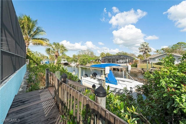 balcony with a boat dock and a water view