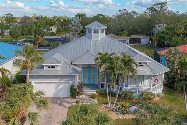 view of front of property with french doors, a porch, and a garage