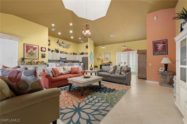 living room with a chandelier, high vaulted ceiling, and light tile patterned flooring