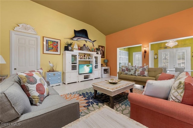 living room with french doors, light tile patterned flooring, and lofted ceiling