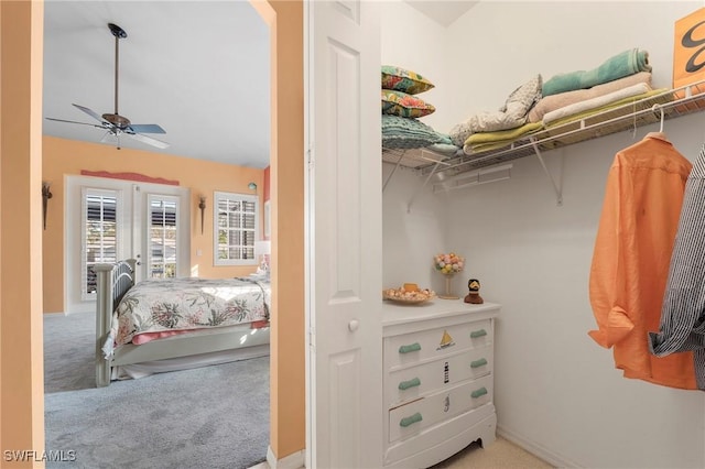 walk in closet featuring ceiling fan and carpet