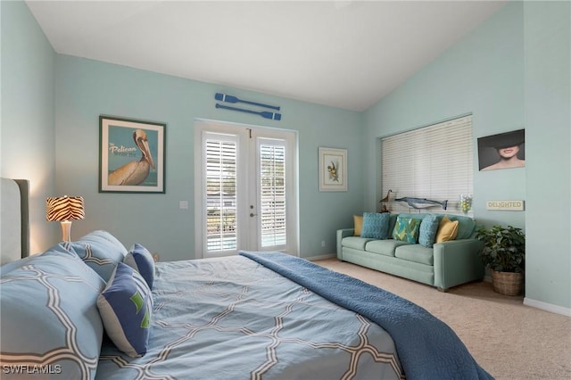 carpeted bedroom with access to exterior, french doors, and vaulted ceiling