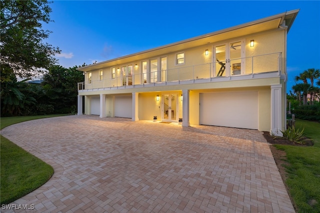 view of front of house featuring a garage and a balcony