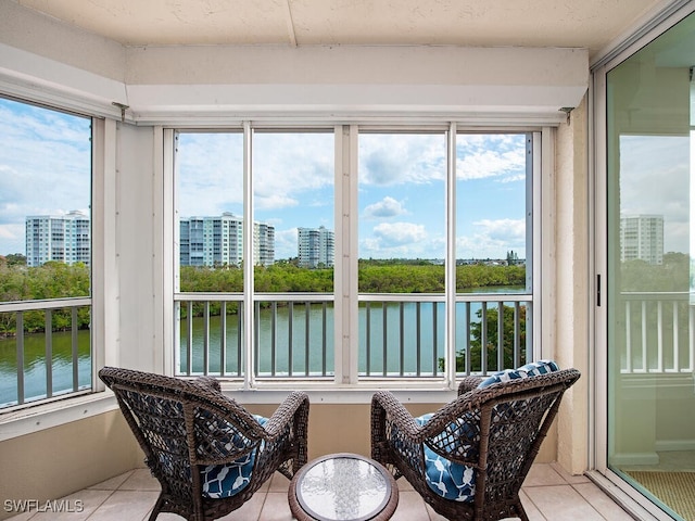 25 Bluebill Ave Unit A-401, Naples, FL 34108 - sunroom / solarium with a water view, tile patterned flooring, and a view of city