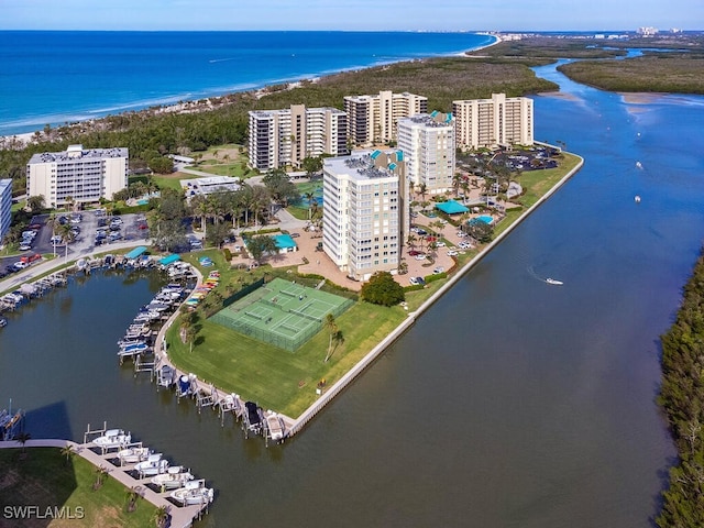 drone / aerial view featuring a beach view and a water view