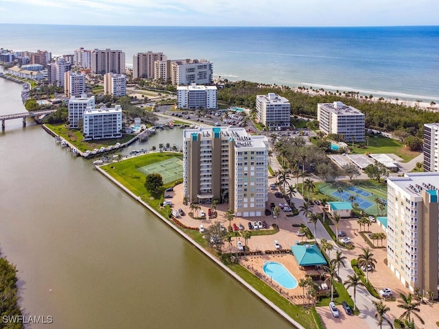 bird's eye view with a water view and a beach view