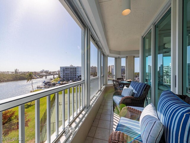 25 Bluebill Ave Unit A-401, Naples, FL 34108 - sunroom featuring a view of city and a water view