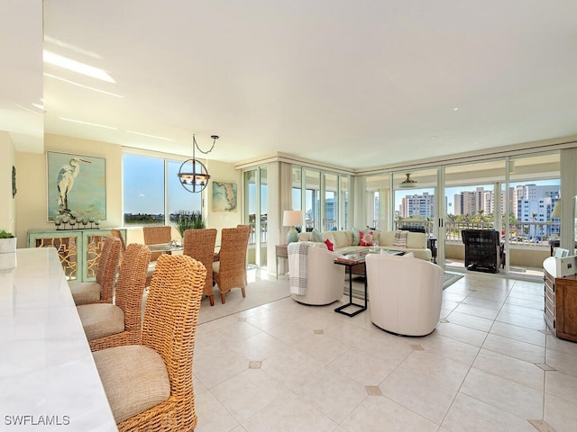 living room with plenty of natural light, light tile patterned floors, and a wall of windows