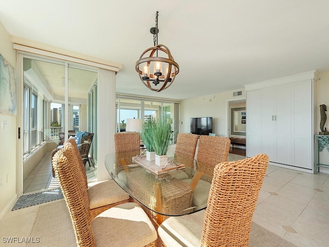 tiled dining space featuring a chandelier