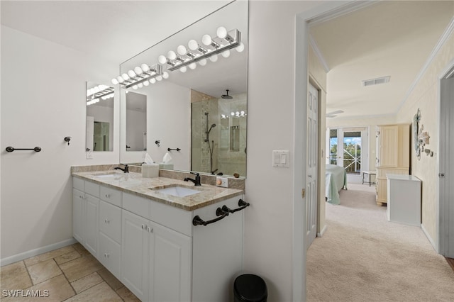 bathroom featuring crown molding, vanity, and a shower with shower door