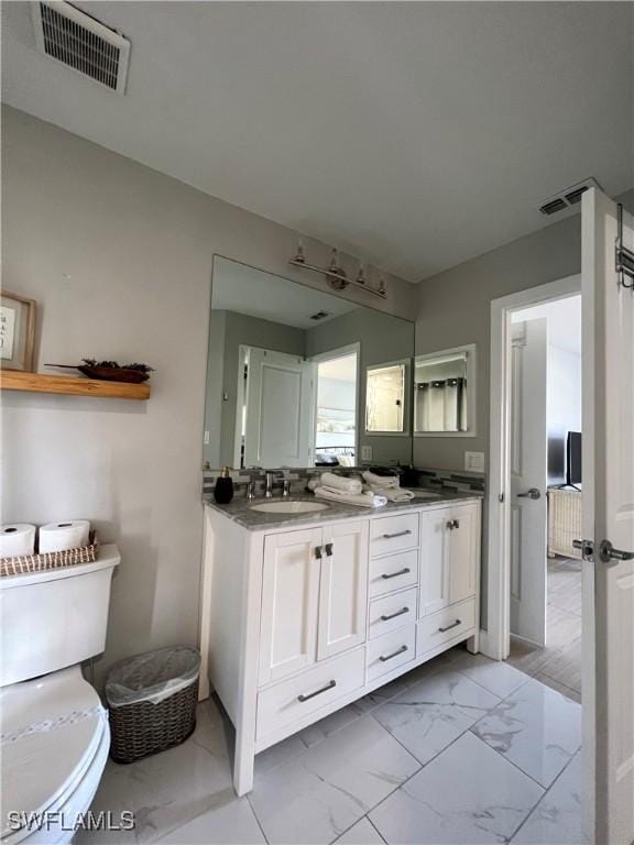 bathroom featuring vanity and toilet