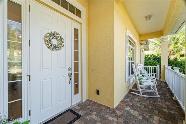 view of exterior entry featuring a porch