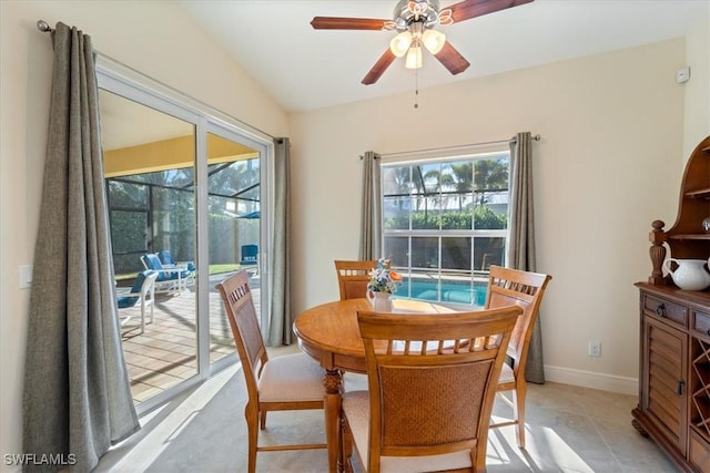 dining room featuring light tile patterned floors, ceiling fan, a wealth of natural light, and lofted ceiling