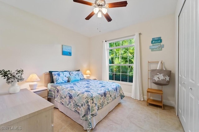 bedroom featuring ceiling fan and a closet