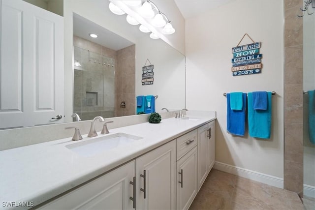 bathroom featuring vanity, tile patterned flooring, and a tile shower