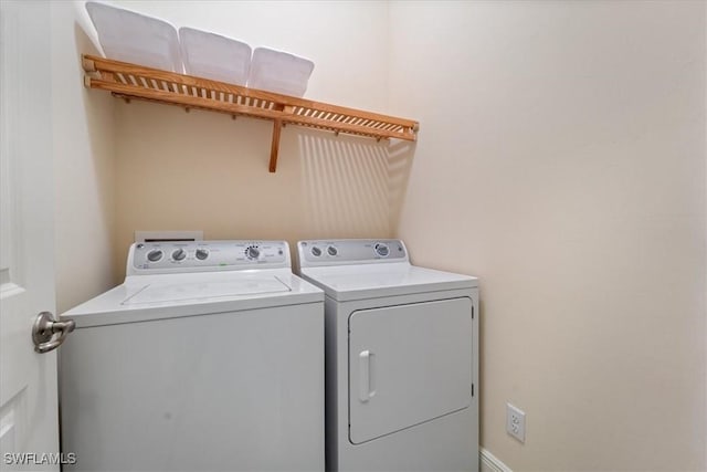 washroom with washing machine and clothes dryer