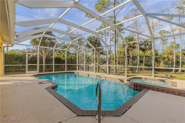 view of pool with a lanai, an in ground hot tub, and a patio