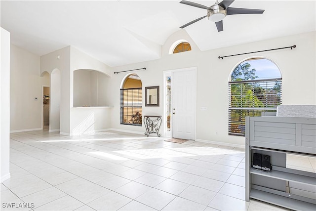 unfurnished living room featuring ceiling fan and light tile patterned flooring