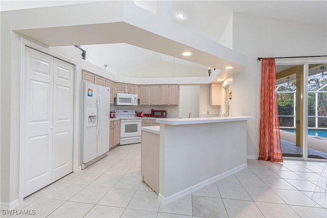 kitchen featuring lofted ceiling, white appliances, kitchen peninsula, and light brown cabinetry