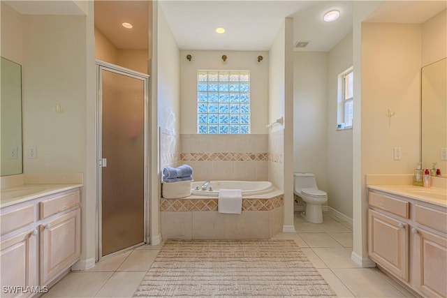 full bathroom featuring tile patterned floors, separate shower and tub, vanity, and toilet