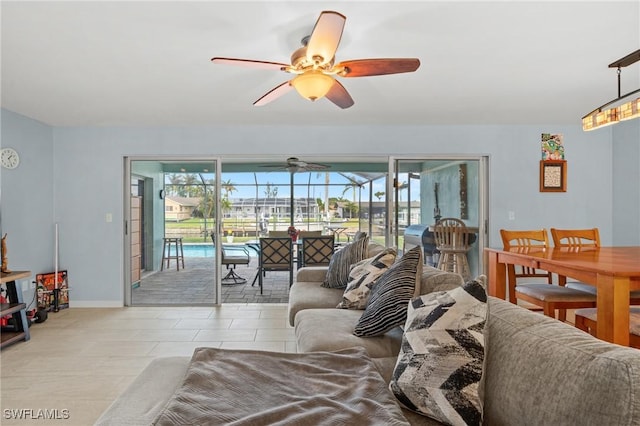 tiled living room with ceiling fan