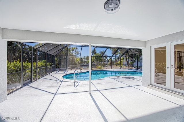 view of pool featuring a lanai, a patio, and french doors