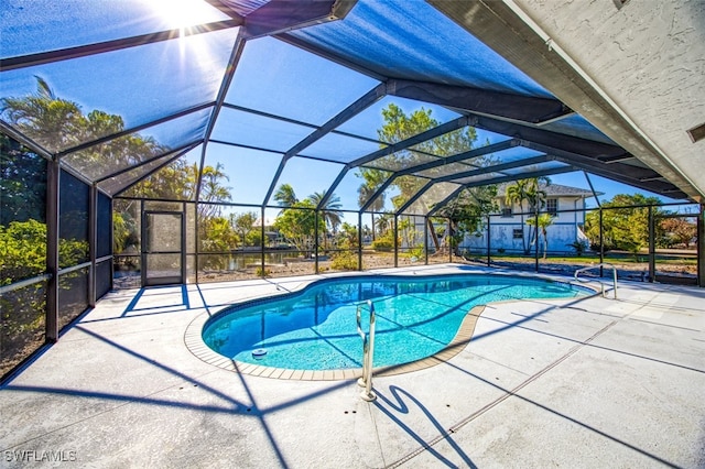 view of swimming pool with a patio and glass enclosure