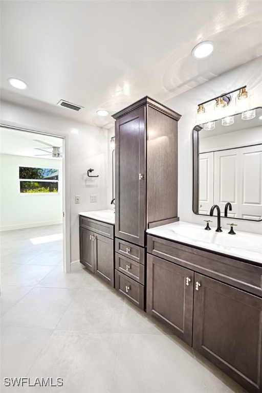 bathroom with tile patterned flooring and vanity