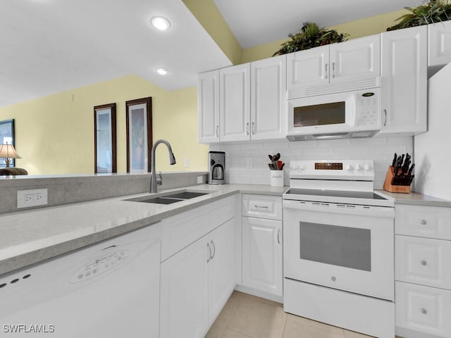 kitchen with white appliances, white cabinets, sink, decorative backsplash, and light tile patterned floors