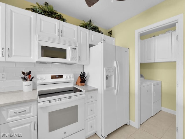 kitchen featuring washing machine and clothes dryer, white cabinetry, white appliances, decorative backsplash, and light tile patterned floors