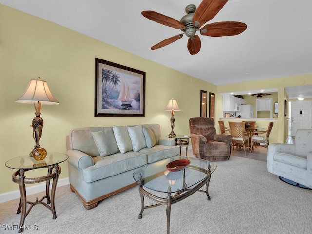 living room featuring ceiling fan and light carpet