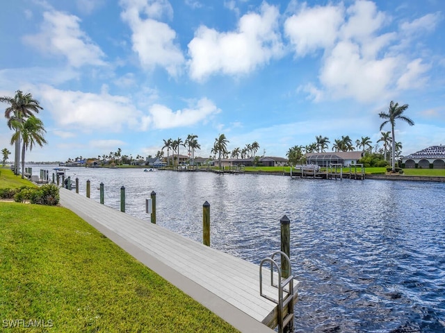 dock area featuring a water view and a lawn